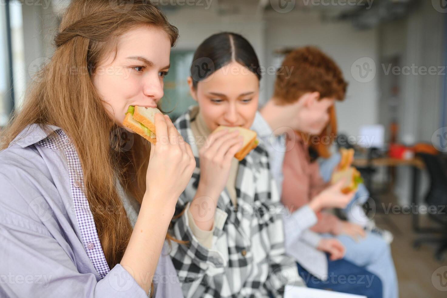 Pupils having lunch in classroom photo
