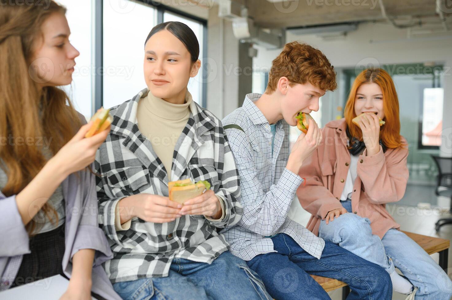 Pupils having lunch in classroom photo