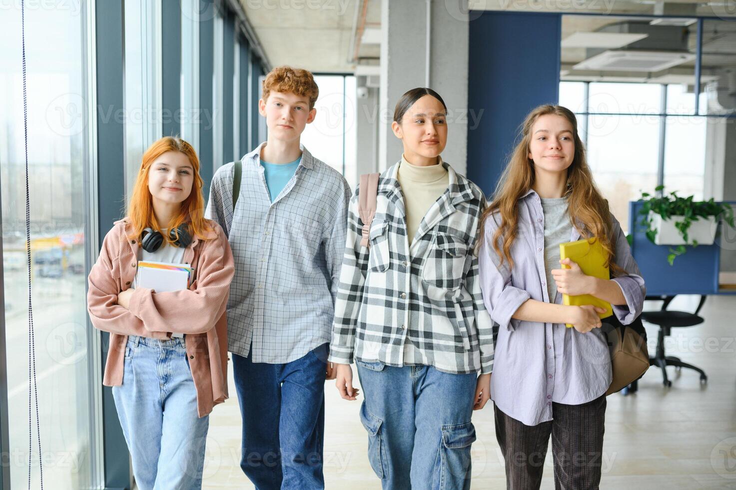 Happy diverse college students posing for group portrait, looking at camera, smiling photo