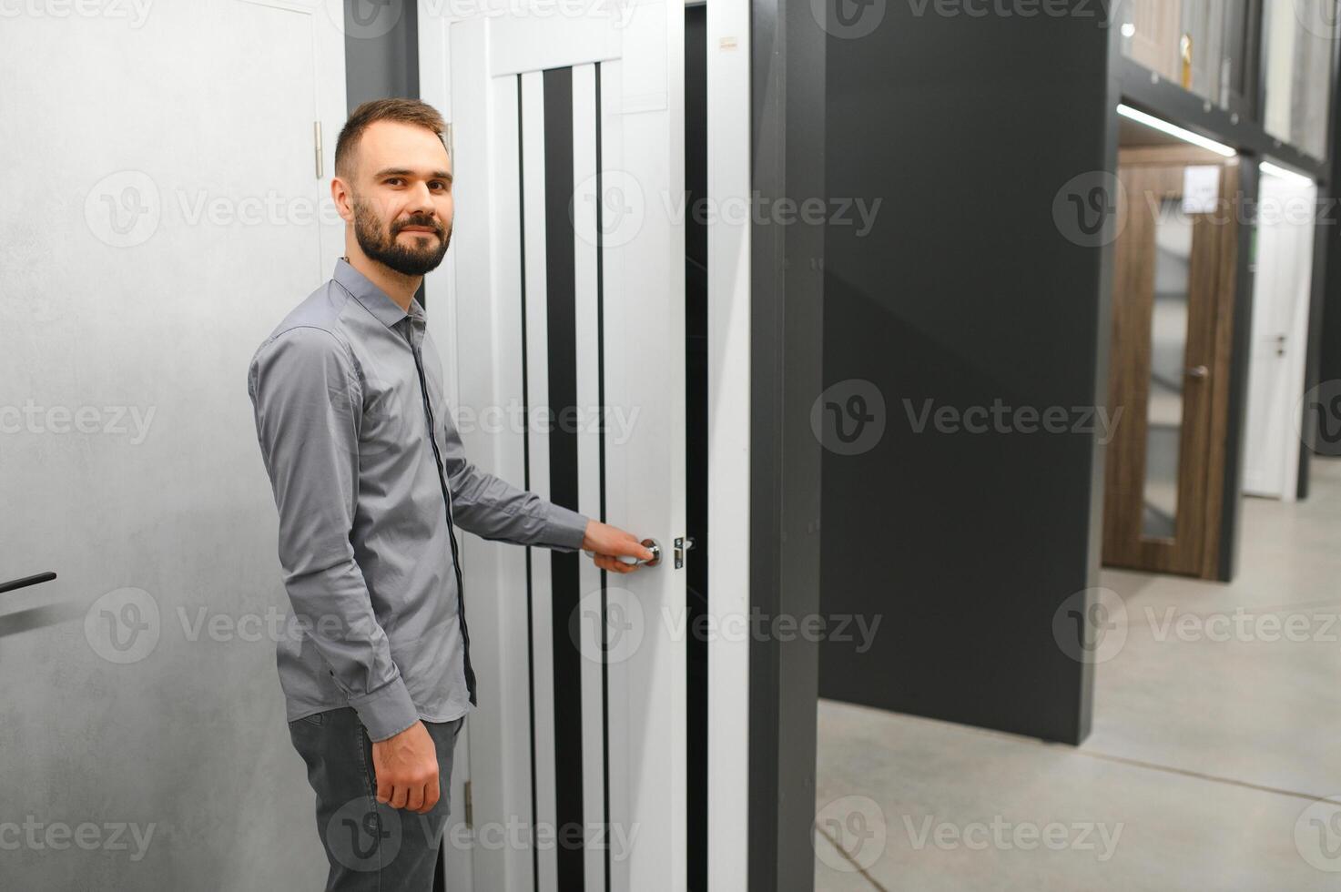 Buyer chooses door in store. Shop window of doors. A large selection of doors for house photo