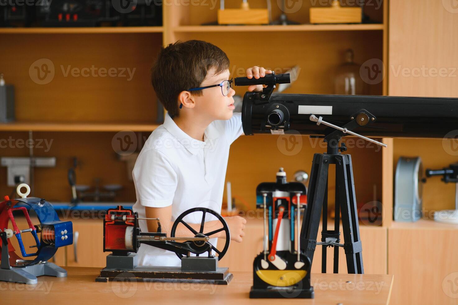 Cute little boy at physics lesson in classroom photo
