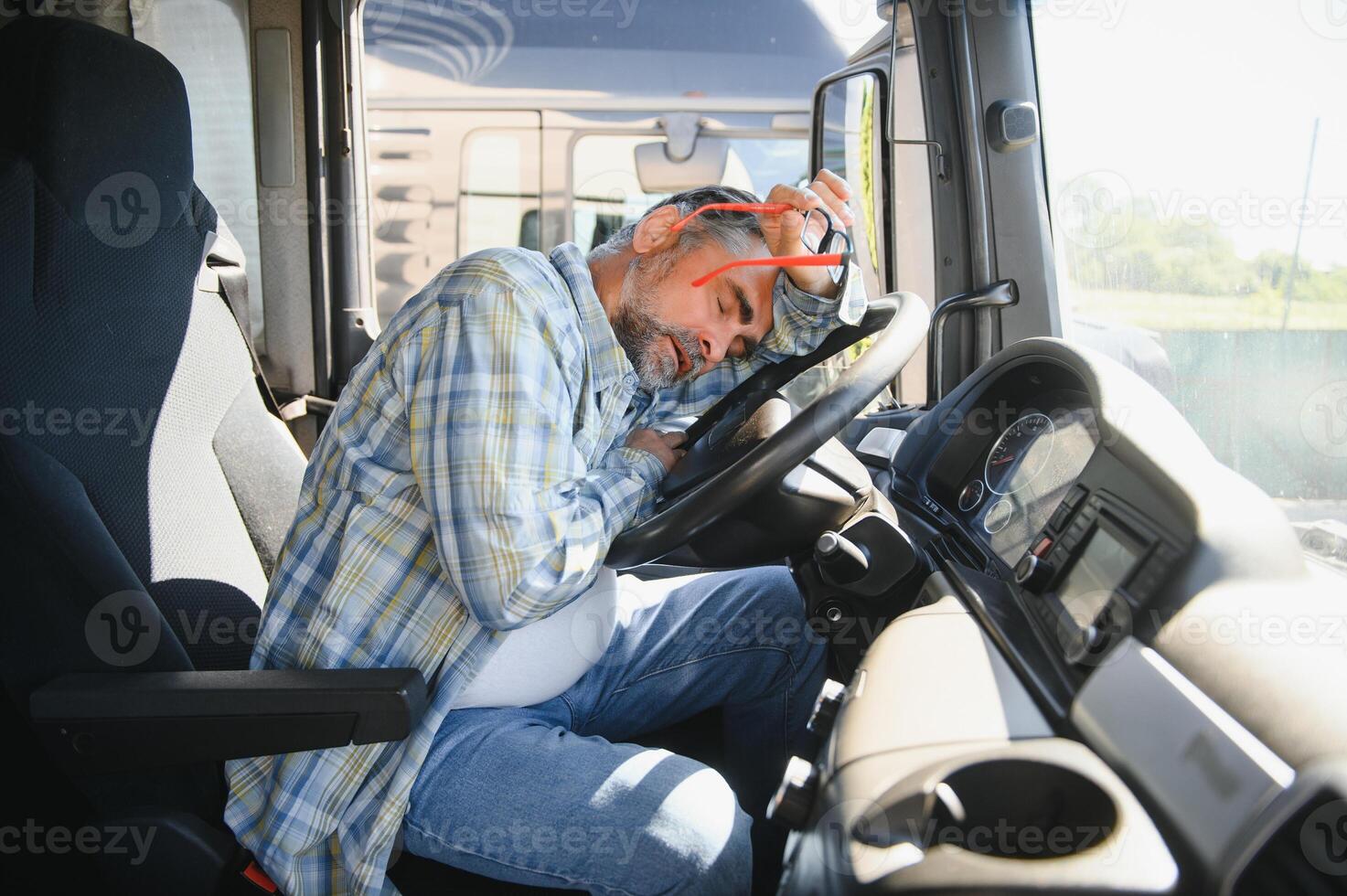 Portrait of tired truck driver feeling sleepy and sick photo