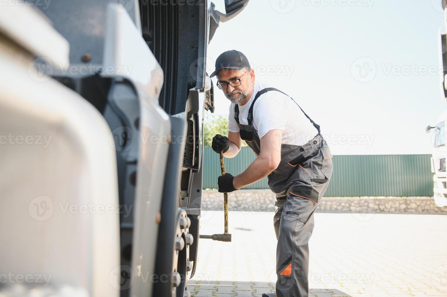 Caucasian Professional Truck Mechanic Rebuilding Heavy Duty Truck Diesel Engine. Automotive Industry Theme photo