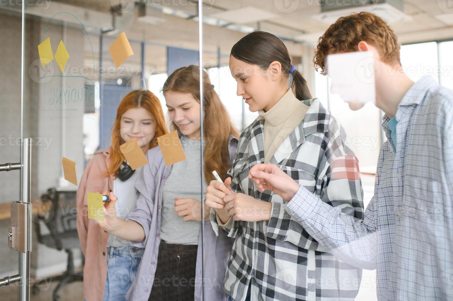 students discuss university assignments together photo