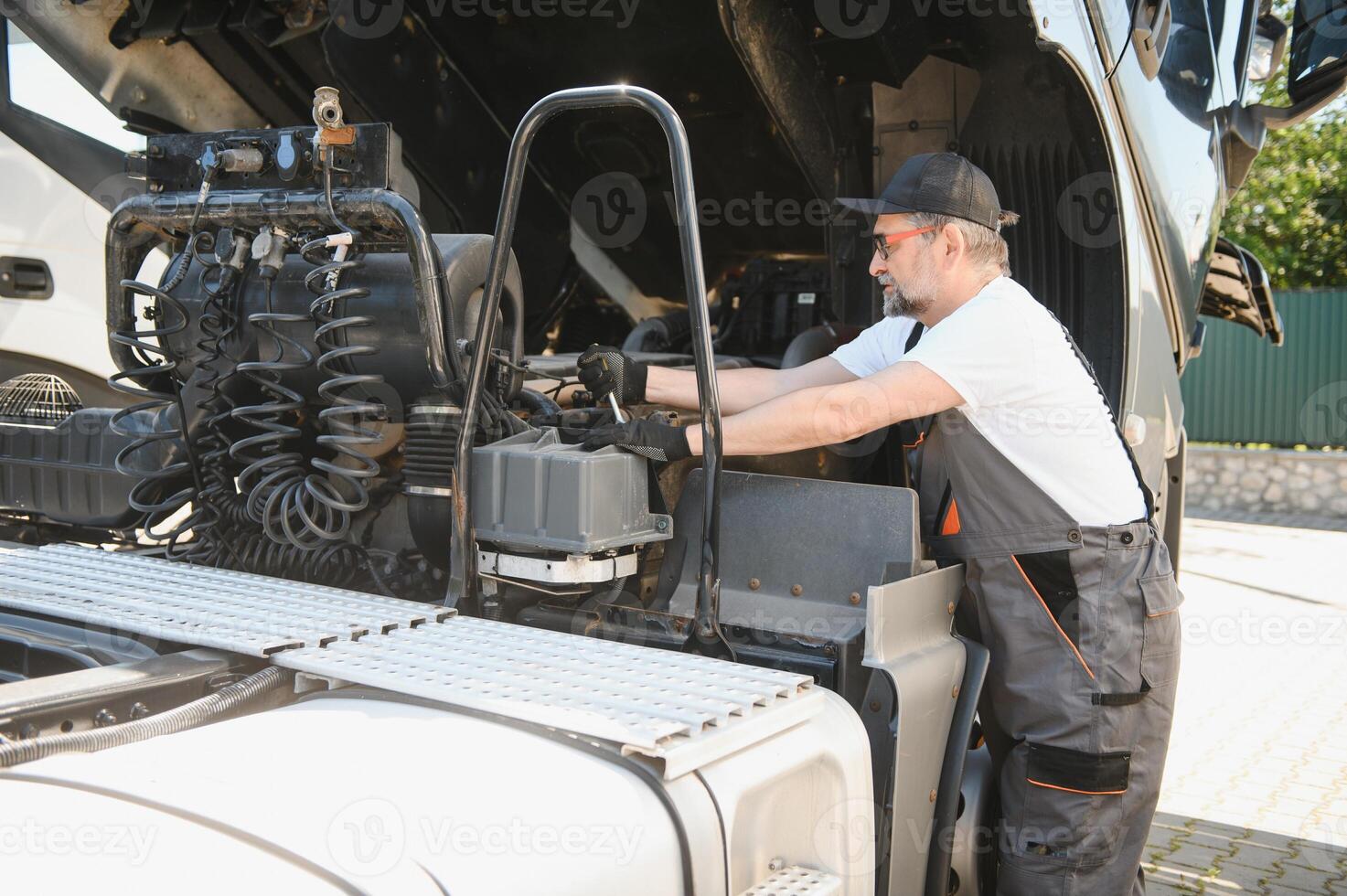 Mechanic repairing the truck in the garage photo