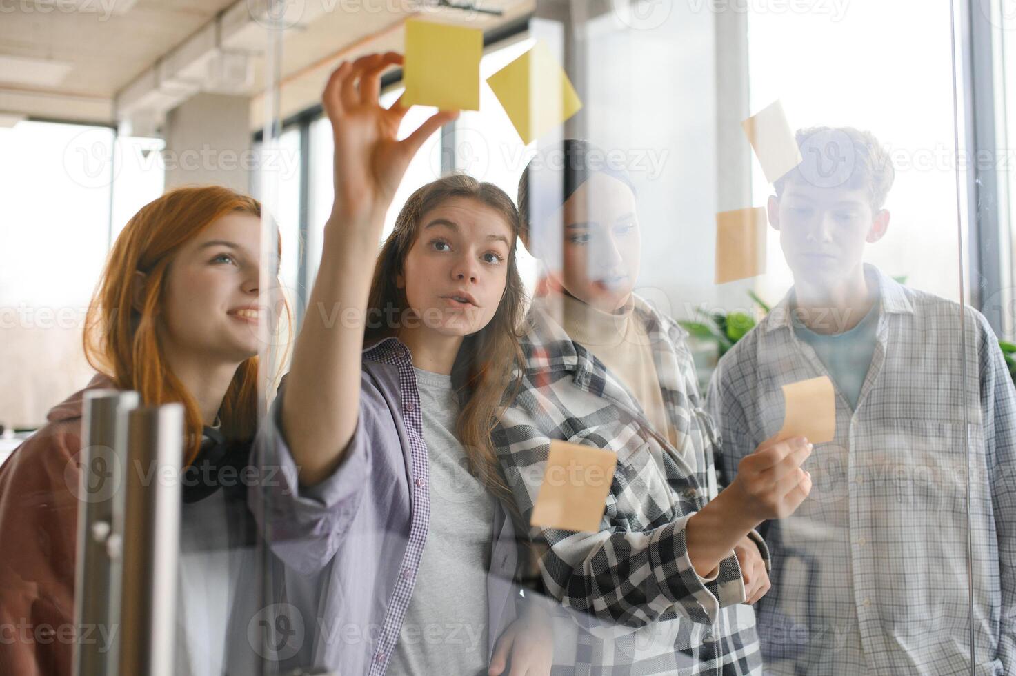 students discuss university assignments together photo