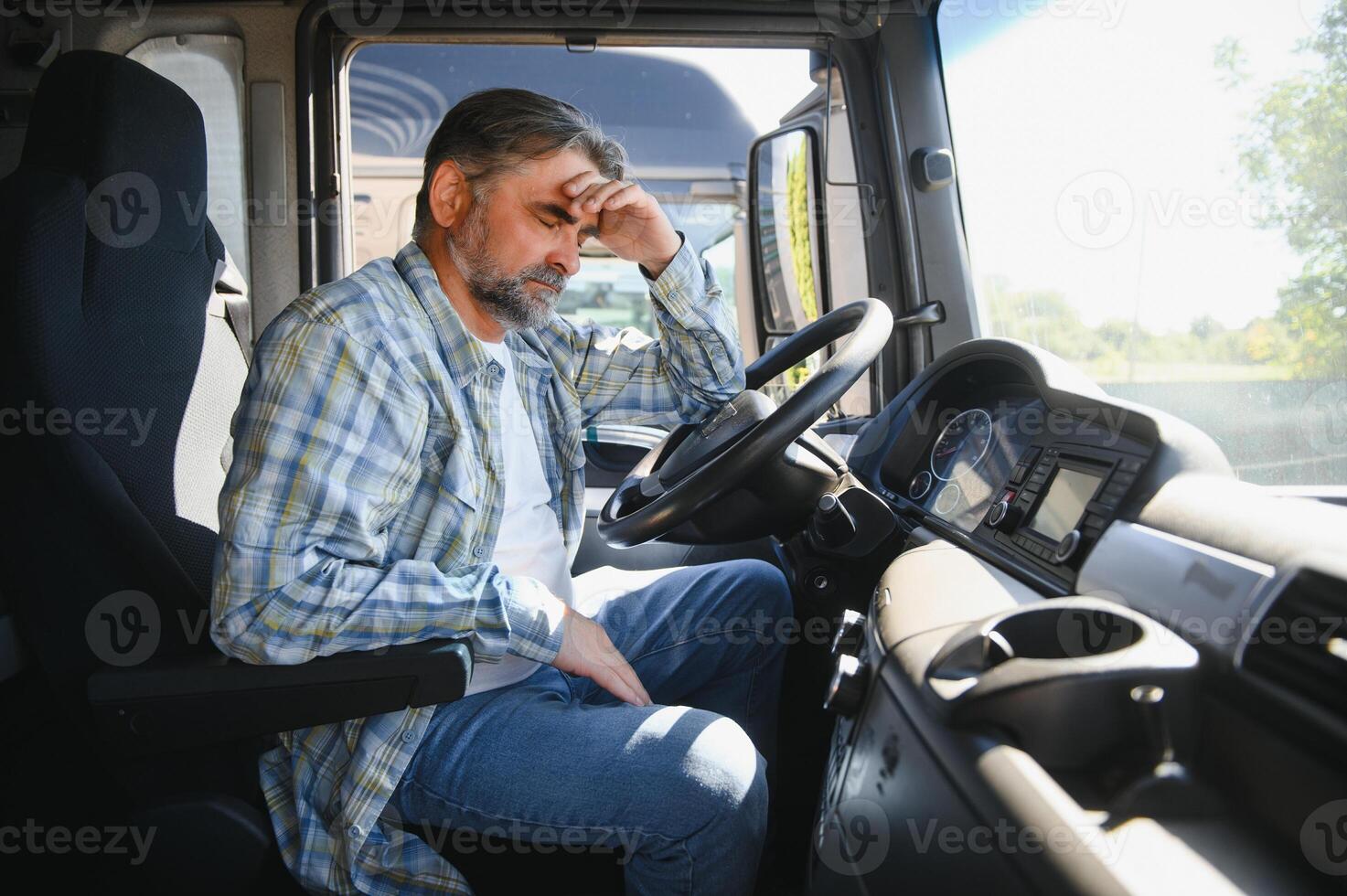 Portrait of tired truck driver feeling sleepy and sick photo