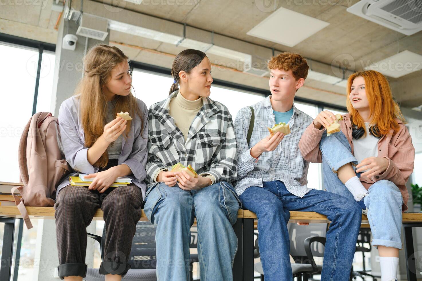 Pupils having lunch in classroom photo