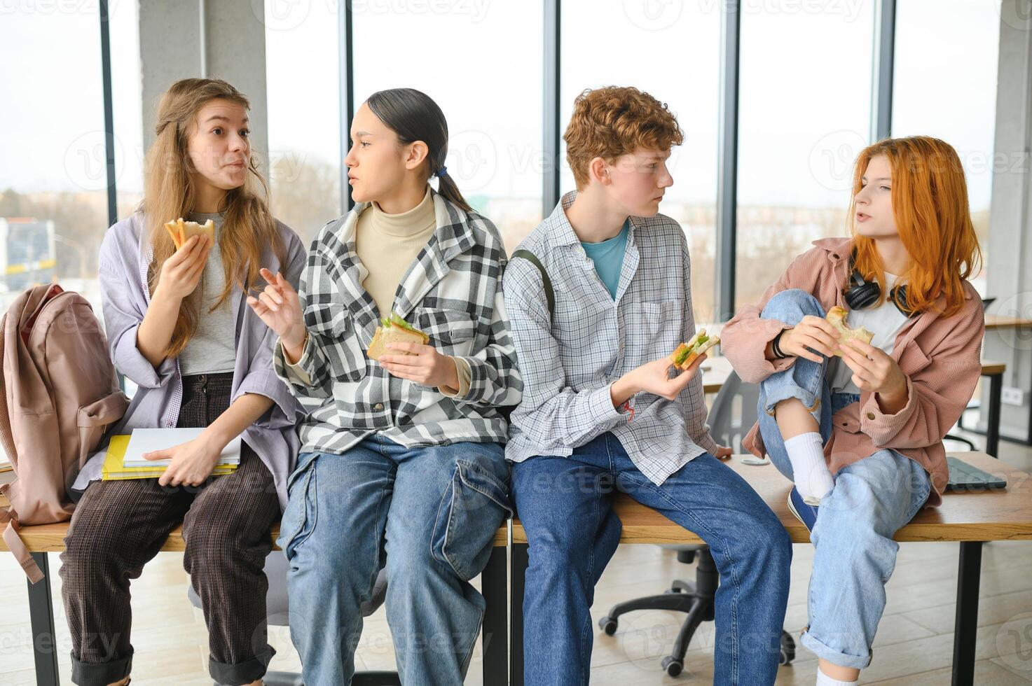 Happy high school students in the classroom photo