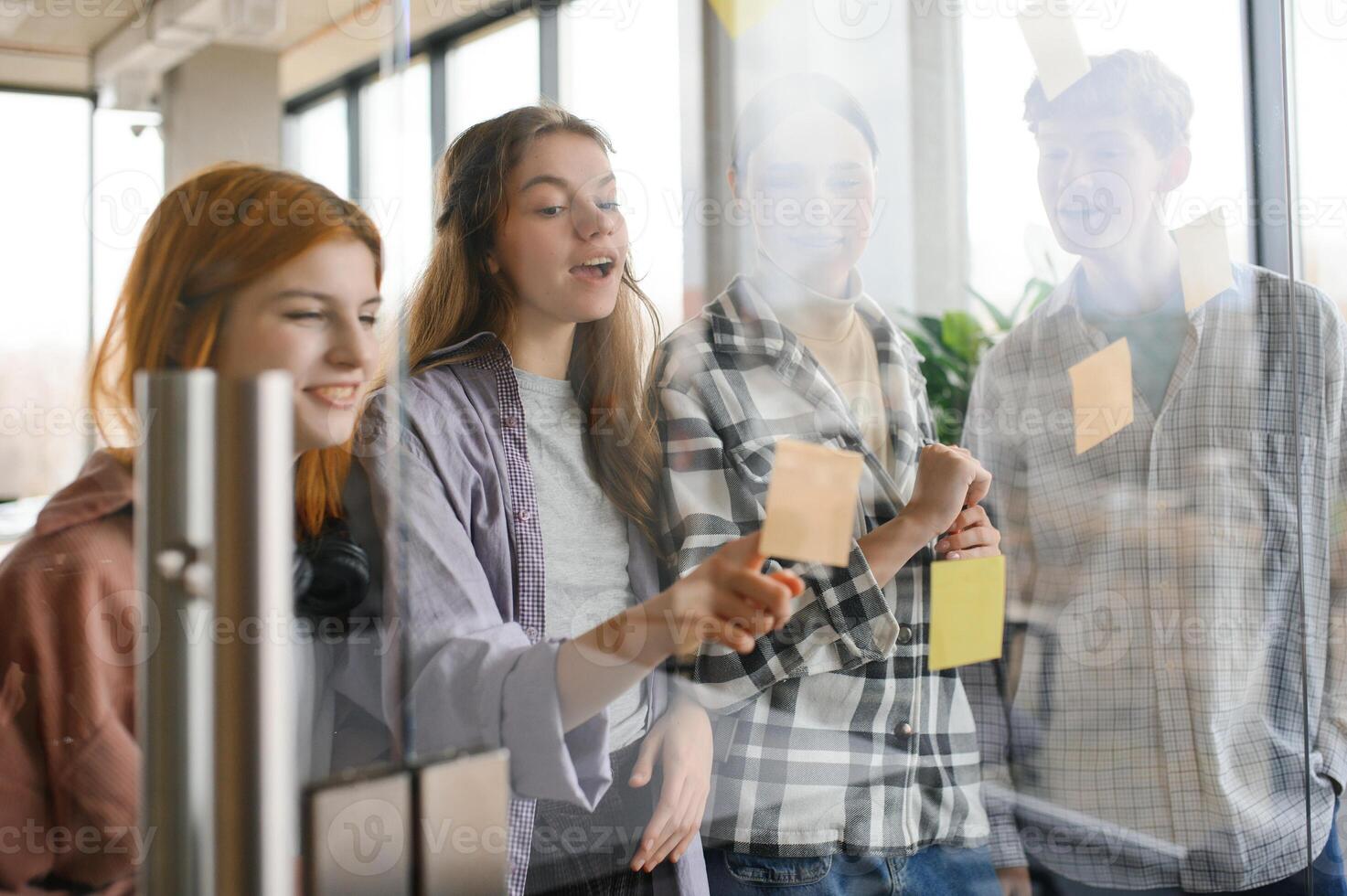students discuss university assignments together photo