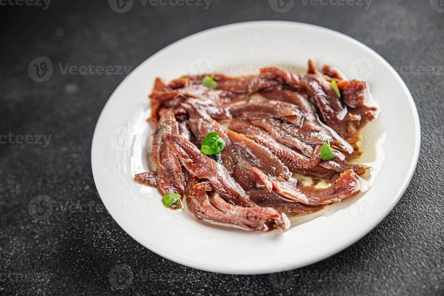 anchovies in a plate on the table canned fish in oil fresh and tasty seafood meal food snack on the table copy space food background rustic photo