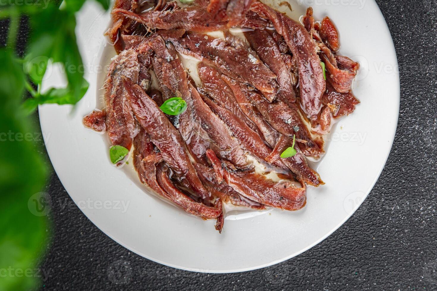 anchovies in a plate on the table canned fish in oil fresh and tasty seafood meal food snack on the table copy space food background rustic photo