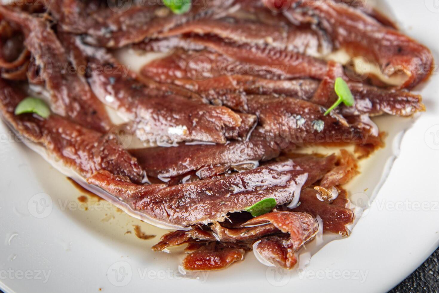anchovies in a plate on the table canned fish in oil fresh and tasty seafood meal food snack on the table copy space food background rustic photo