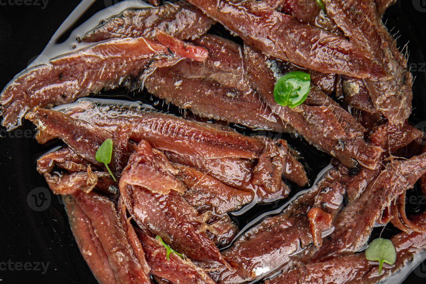 anchovies in a plate on the table canned fish in oil fresh and tasty seafood meal food snack on the table copy space food background rustic photo
