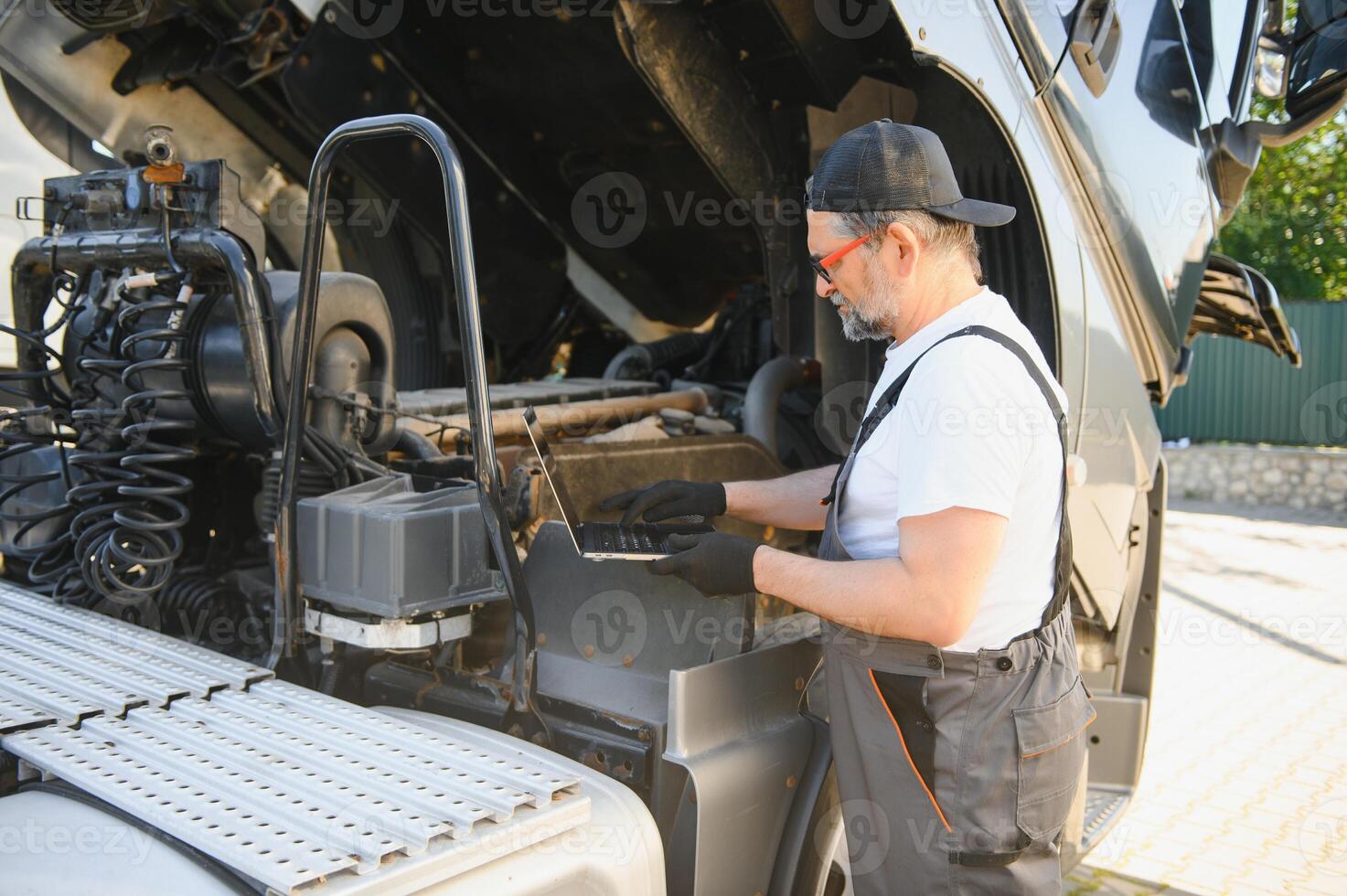 Truck repair service. Mechanic makes computer diagnostic of the semitruck photo