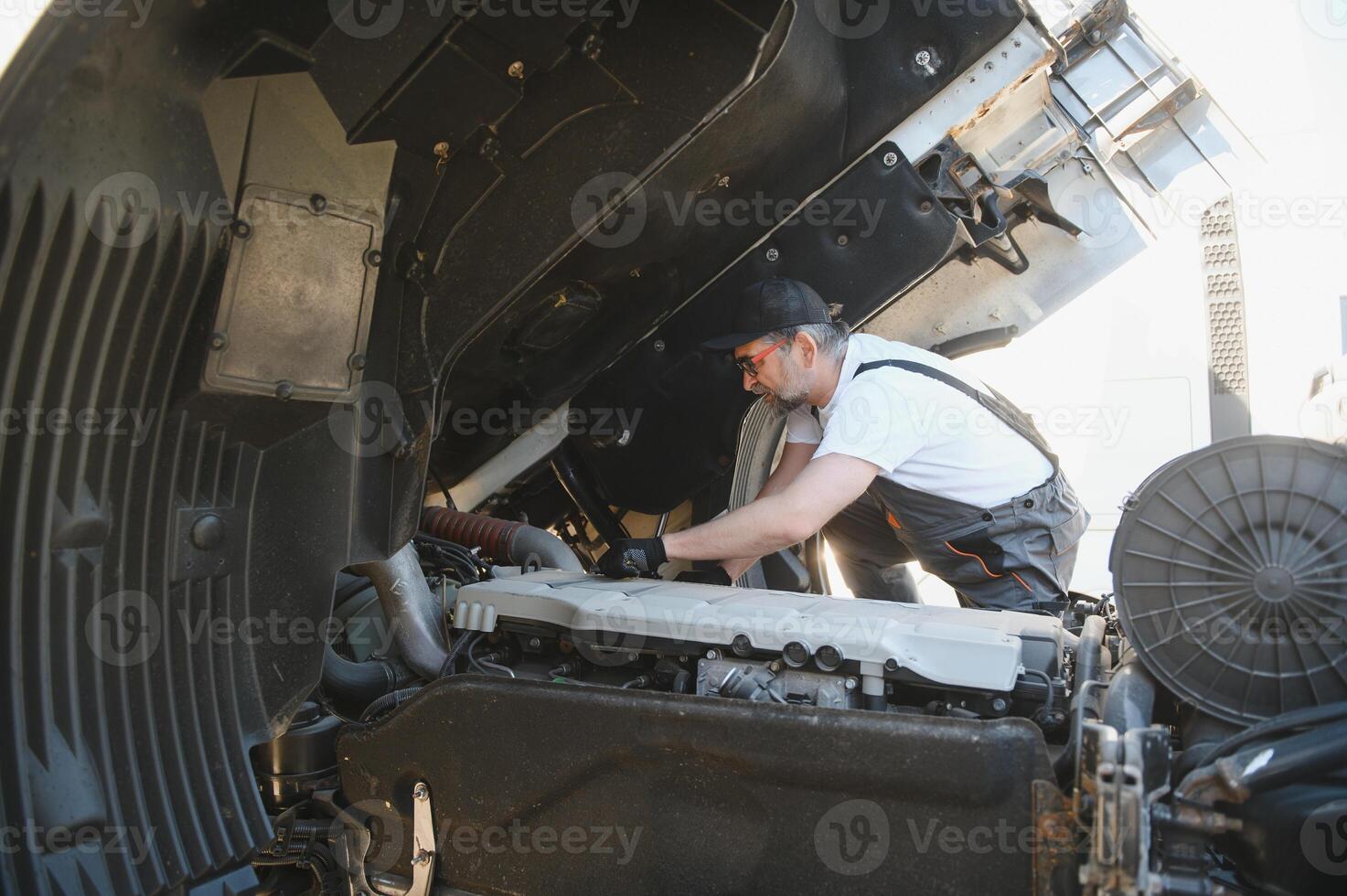 Man in uniform. Truck repair. Car malfunction photo