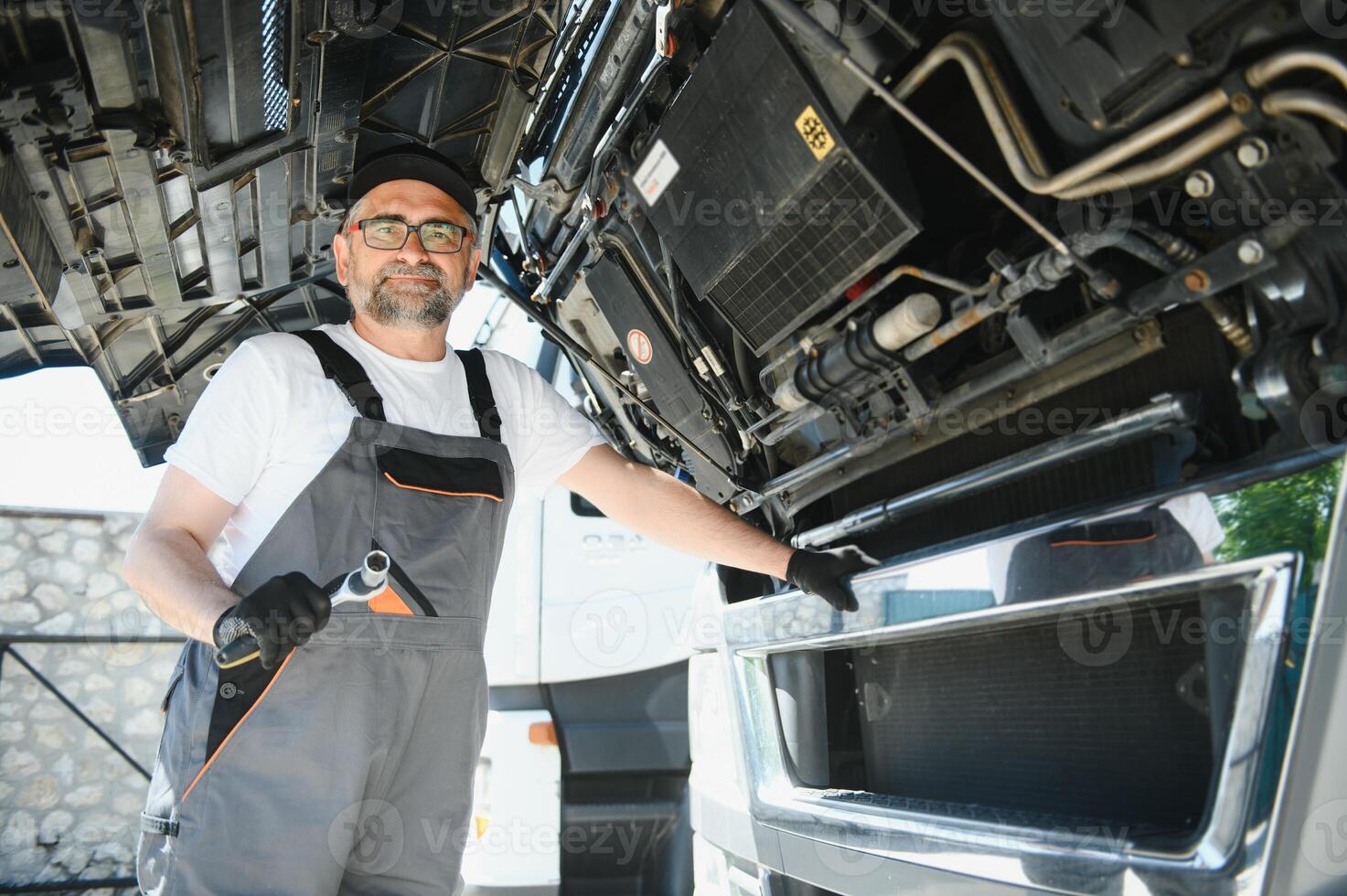 Mechanic repairing the truck in the garage photo