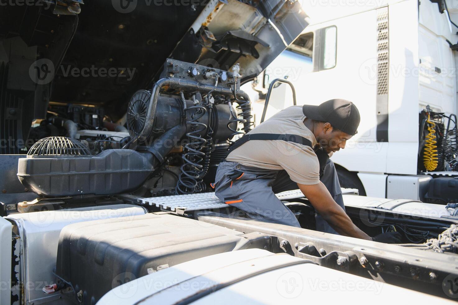 Professional truck mechanic working in vehicle repair service photo