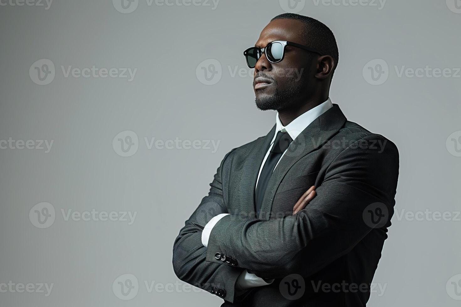 A black man in a business suit stands on a white background in the pose of a boss. Generated by artificial intelligence photo