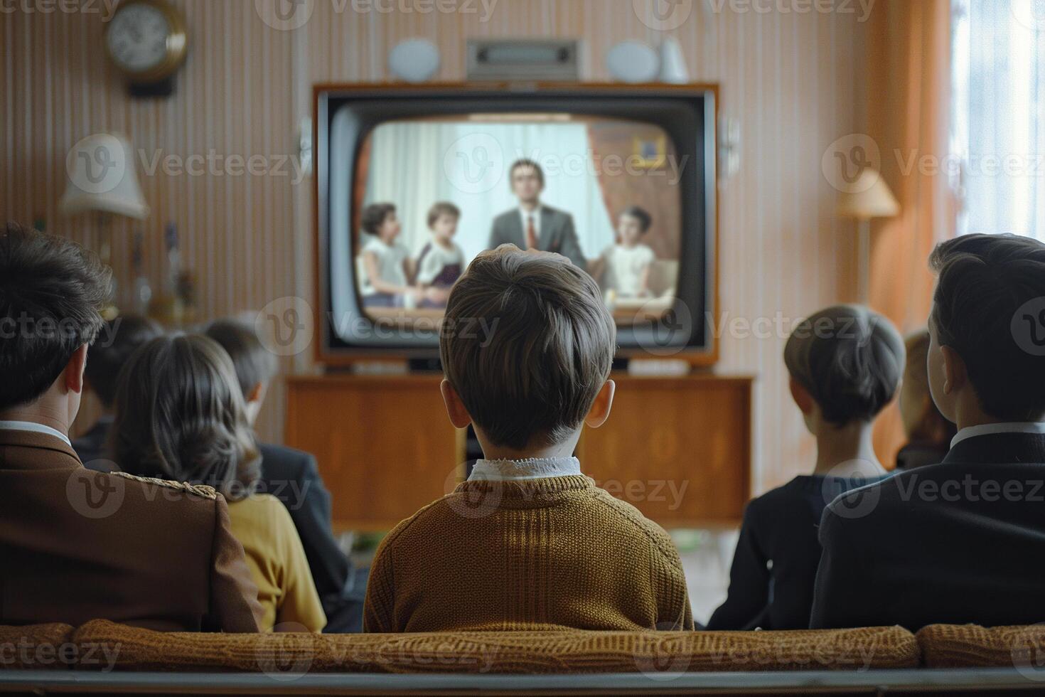 Rear view of a family sitting on a sofa watching TV. photo