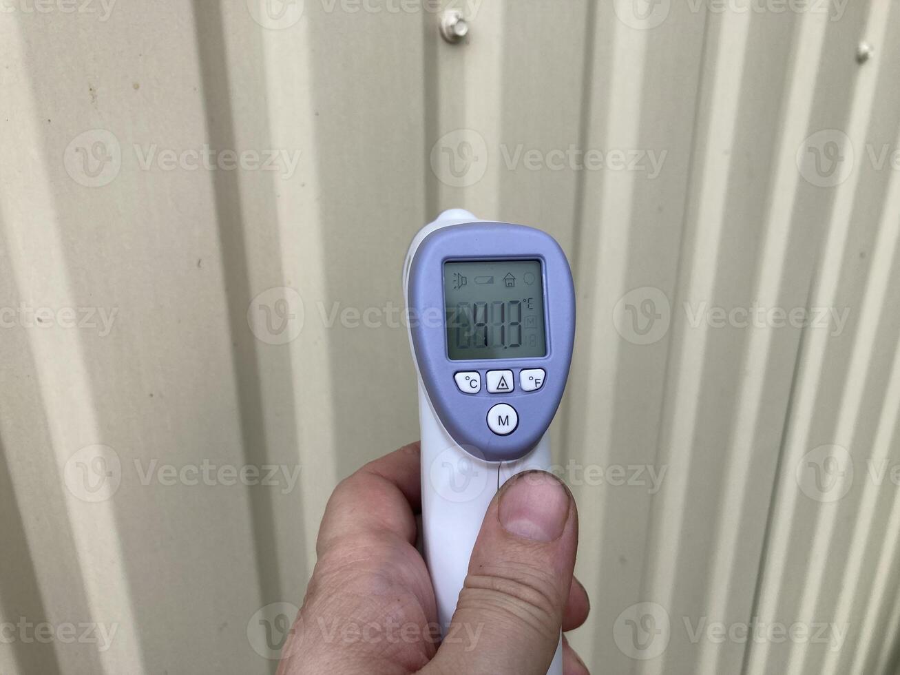 Measuring temperature with a non-contact thermometer photo