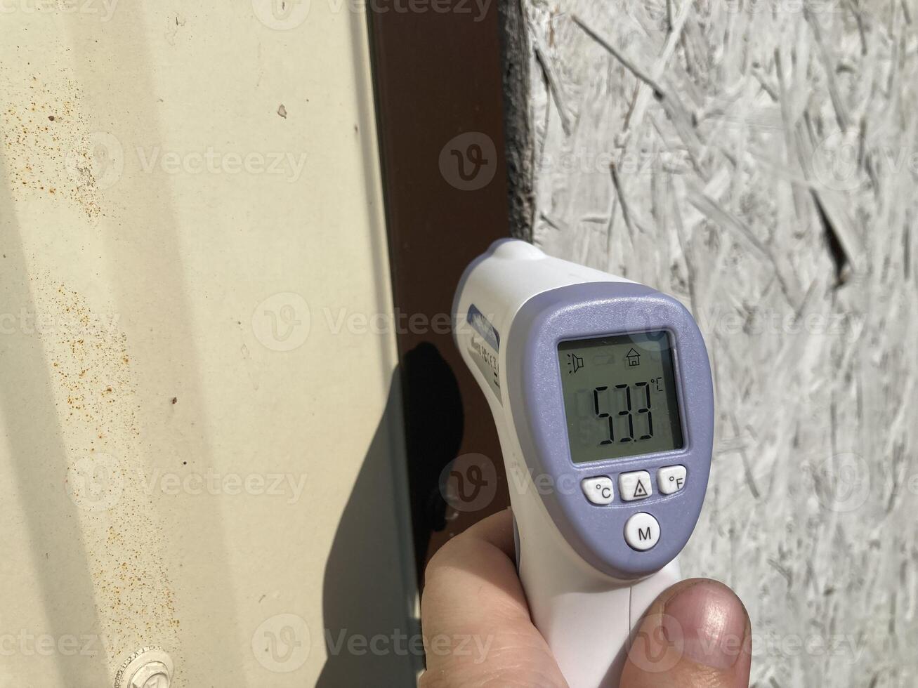 Measuring temperature with a non-contact thermometer photo
