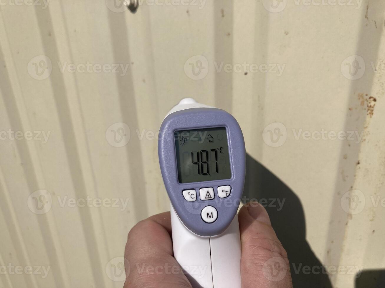 Measuring temperature with a non-contact thermometer photo