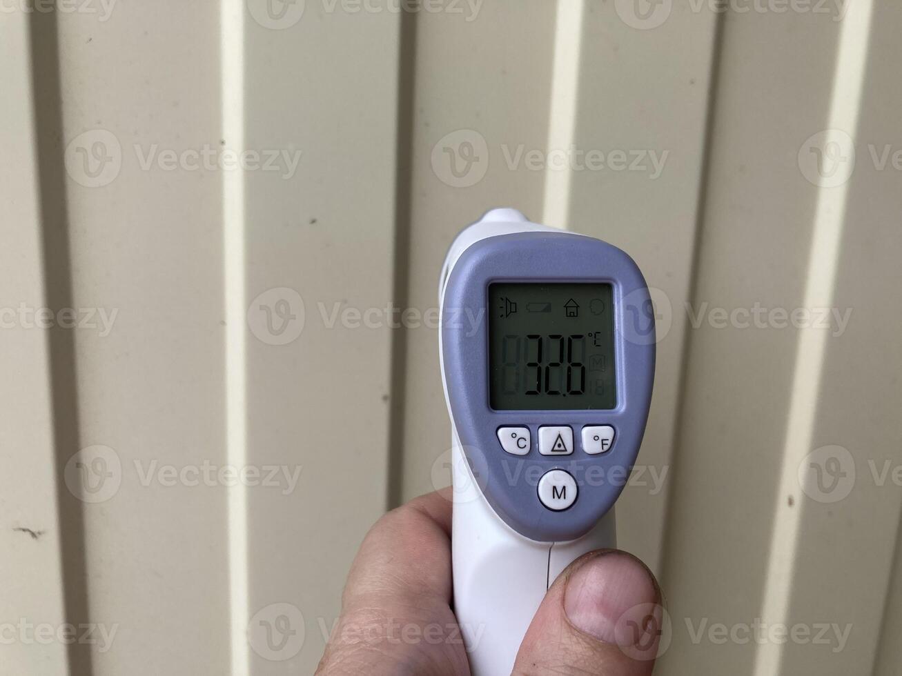 Measuring temperature with a non-contact thermometer photo