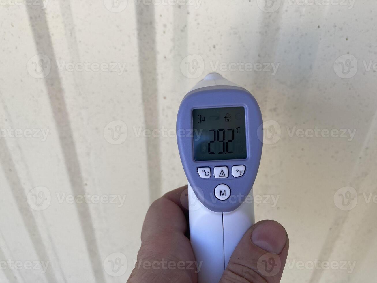 Measuring temperature with a non-contact thermometer photo