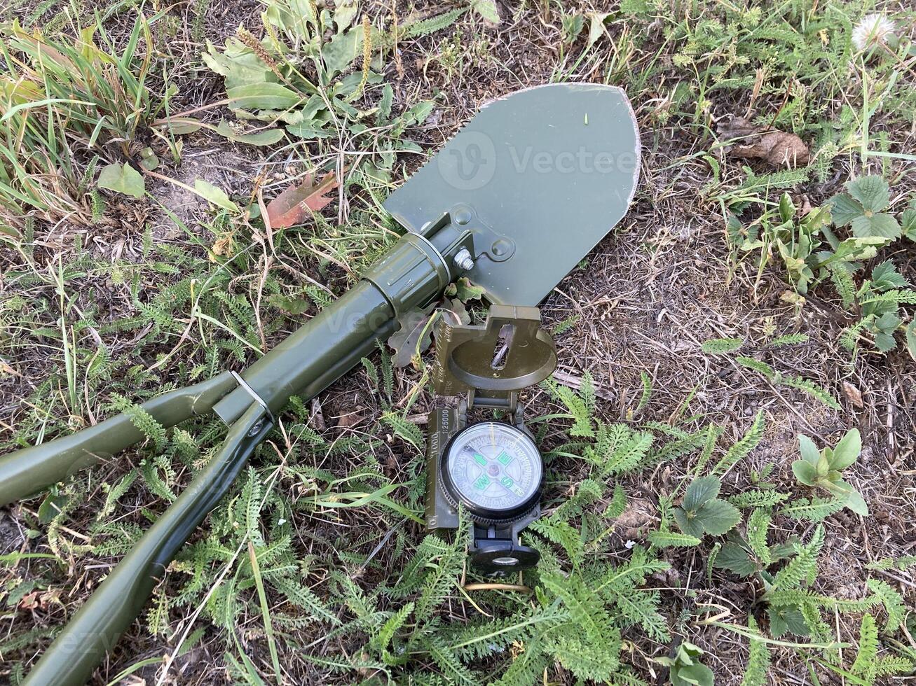 Compass for orientation on the terrain during a hike photo