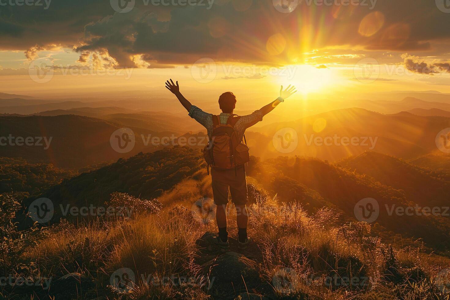 Silhouette of a man standing on top of a mountain. A man stands on a cliff at sunset or dawn. Concept of sport, adventure, success, lifestyle. photo
