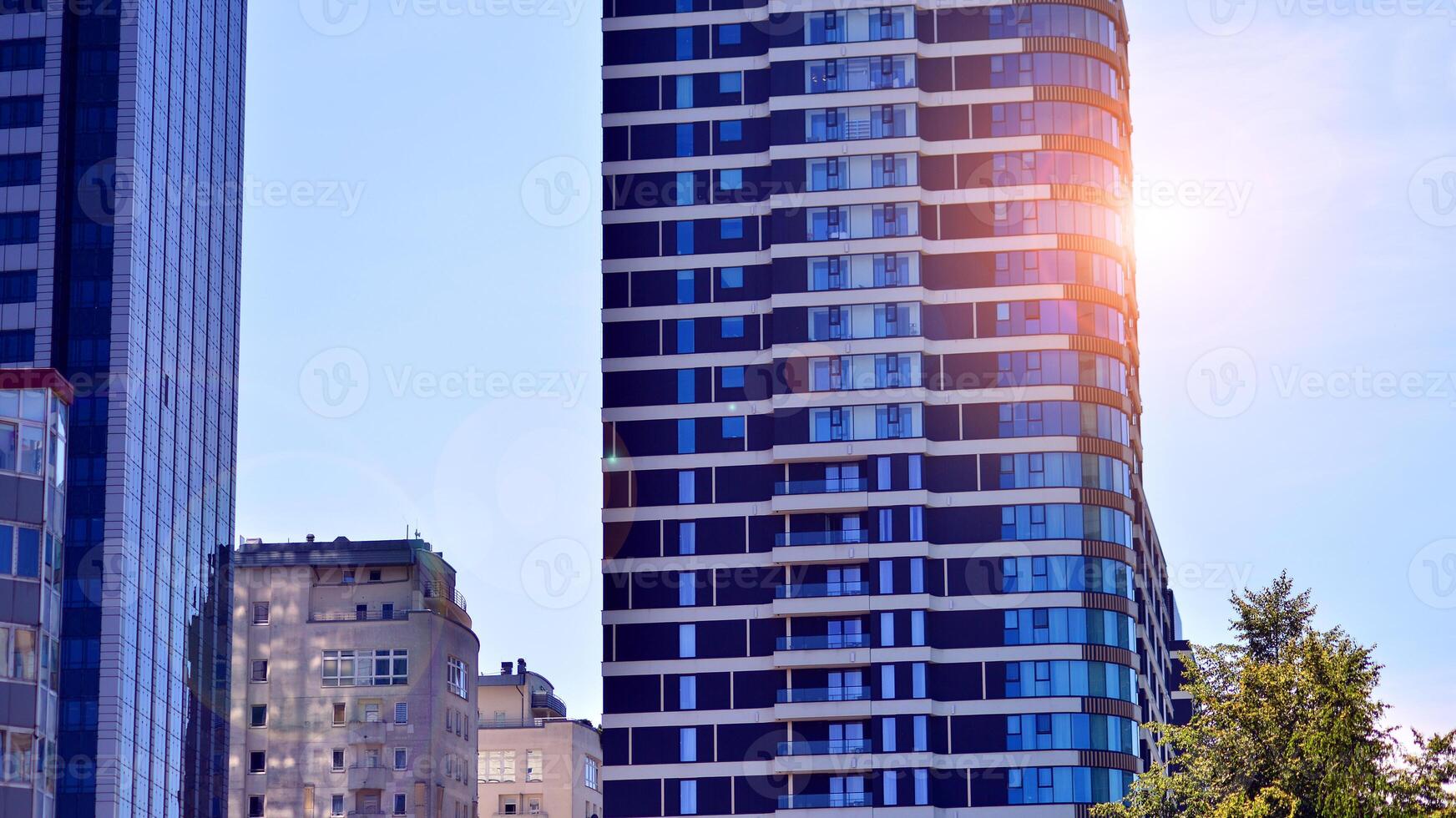 Exterior of a high modern multi-story apartment building - facade, windows and balconies. photo