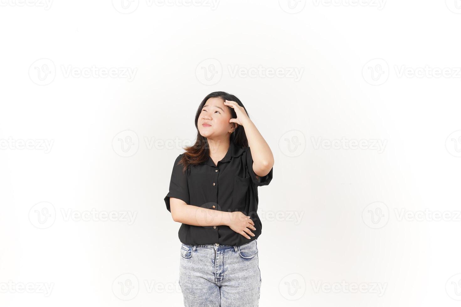 Young Asian woman doing thinking gesture wearing Black t-shirt and jeans isolated on white background photo