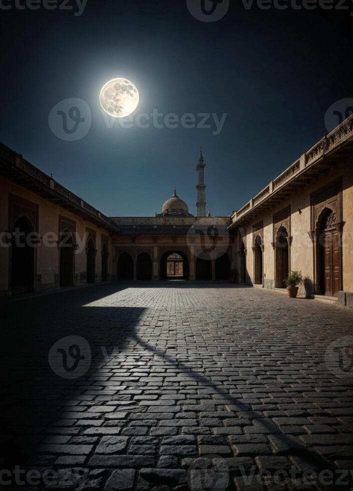 the moon is shining brightly in the night sky over an empty courtyard photo