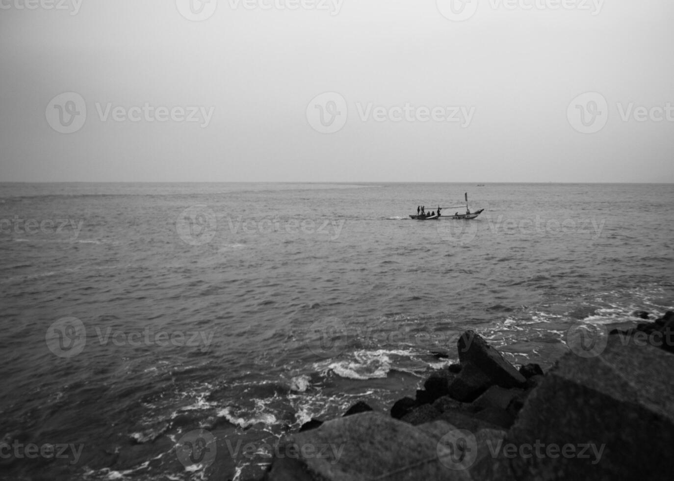 black and white fishing boat sailing out to sea photo