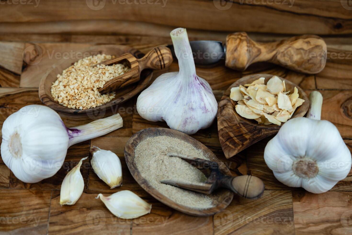 fresh and dried Garlic on olive wood photo