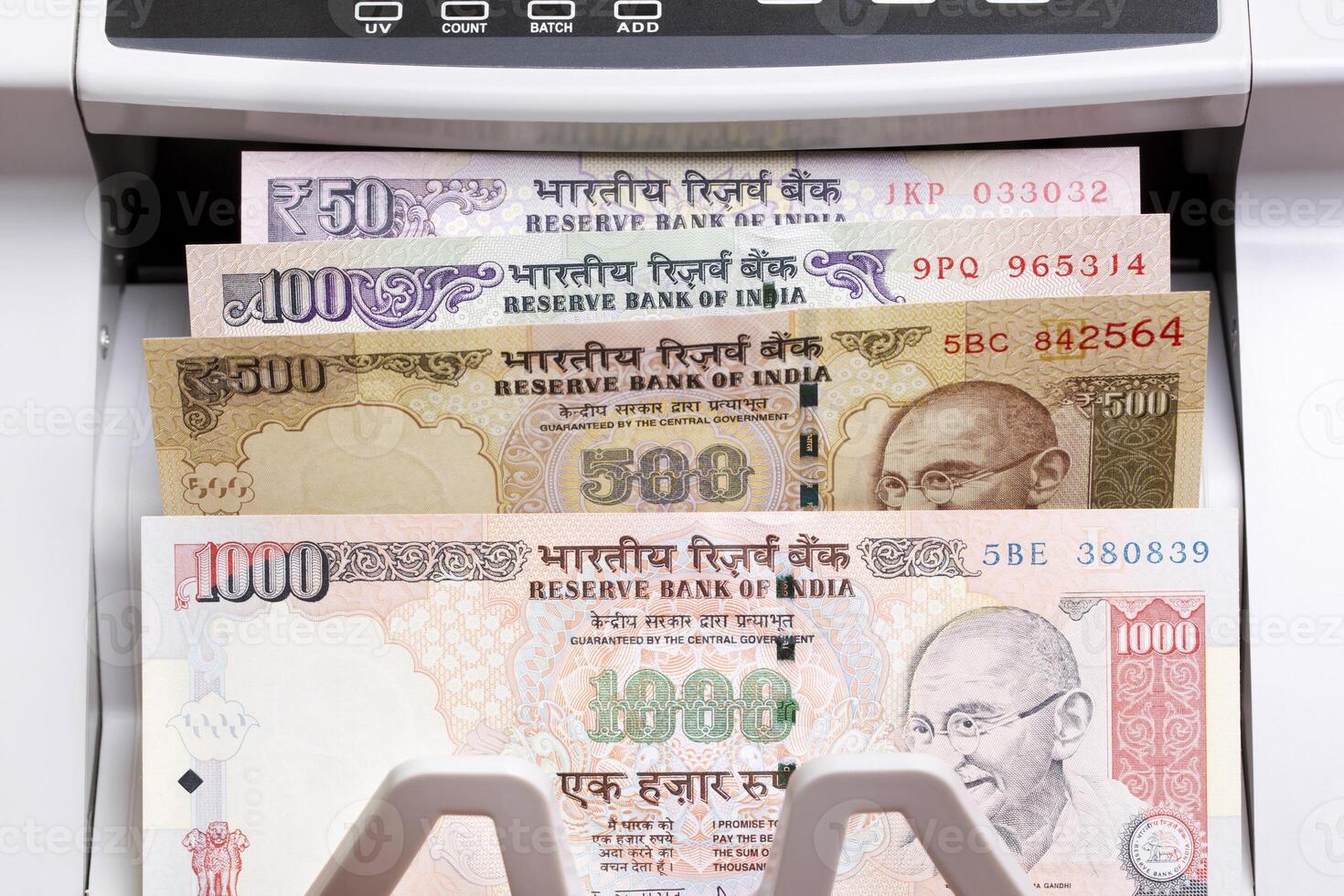 Indian rupees in the counting machine photo