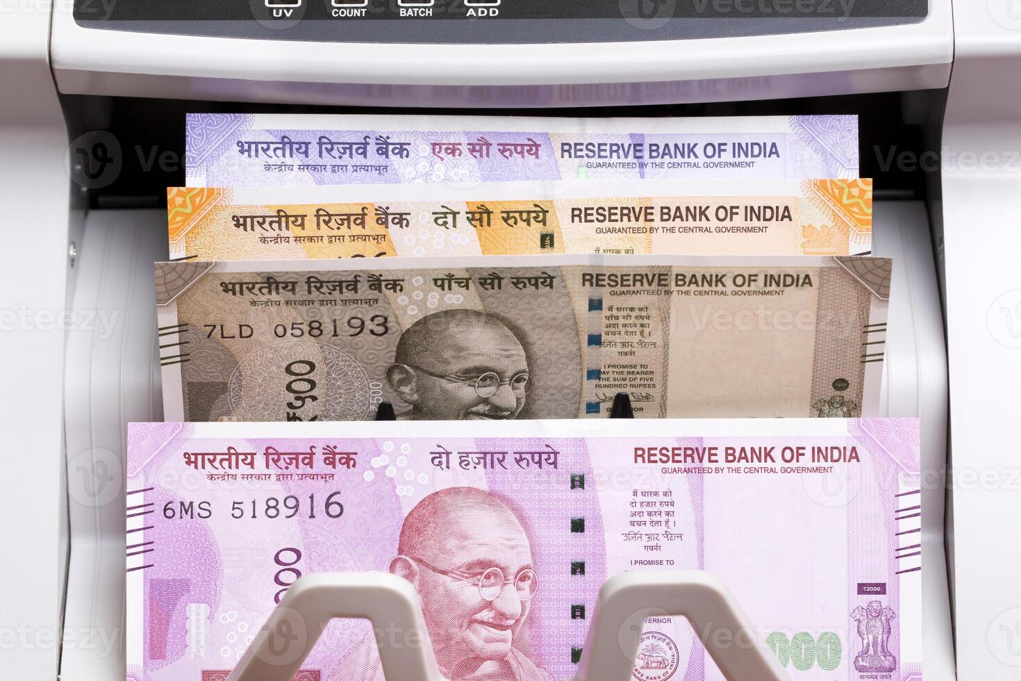 Indian rupees in the counting machine photo