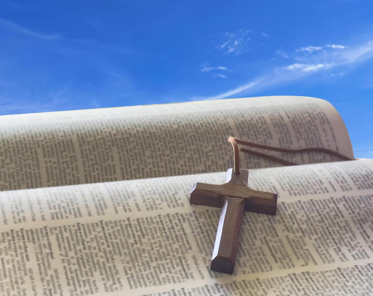 A brown wooden cross resting in an open palm, symbolizing the spreading of Jesus Christ's love to all. photo