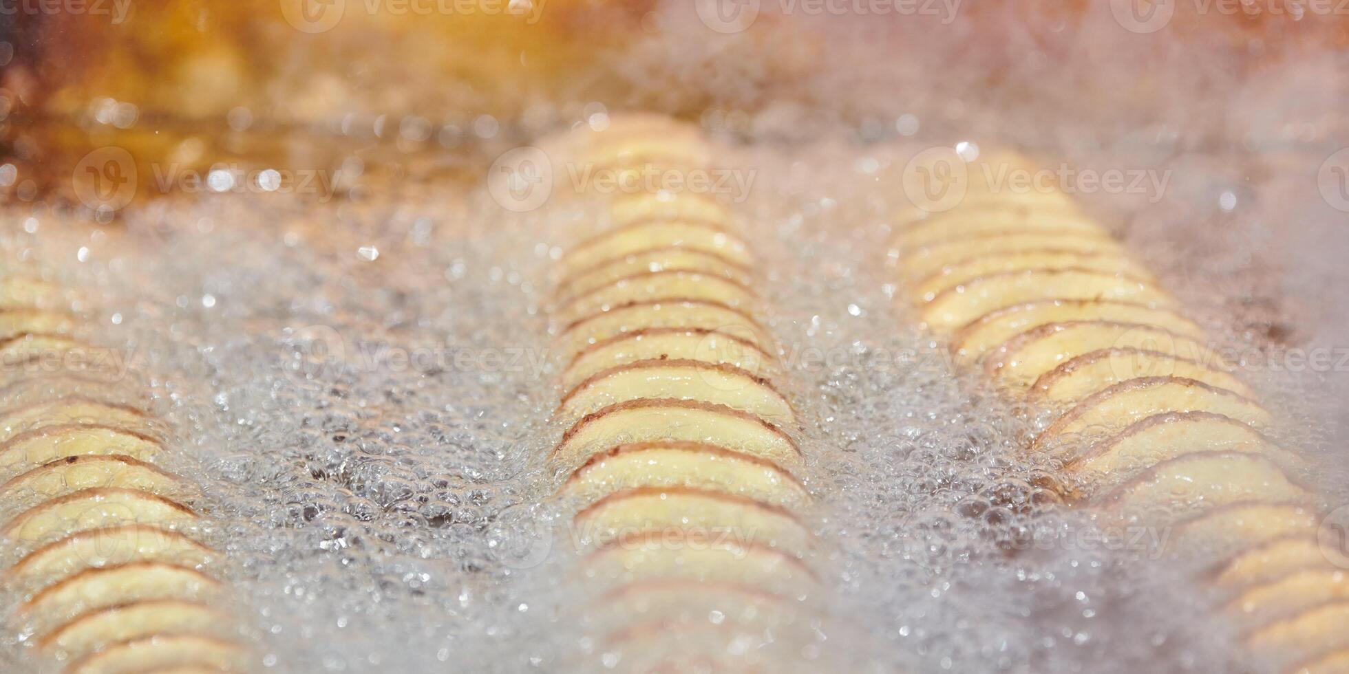 Cooking spiral fried potato in boiling oil, rich in fat and calories fast food, unhealthy delicious photo
