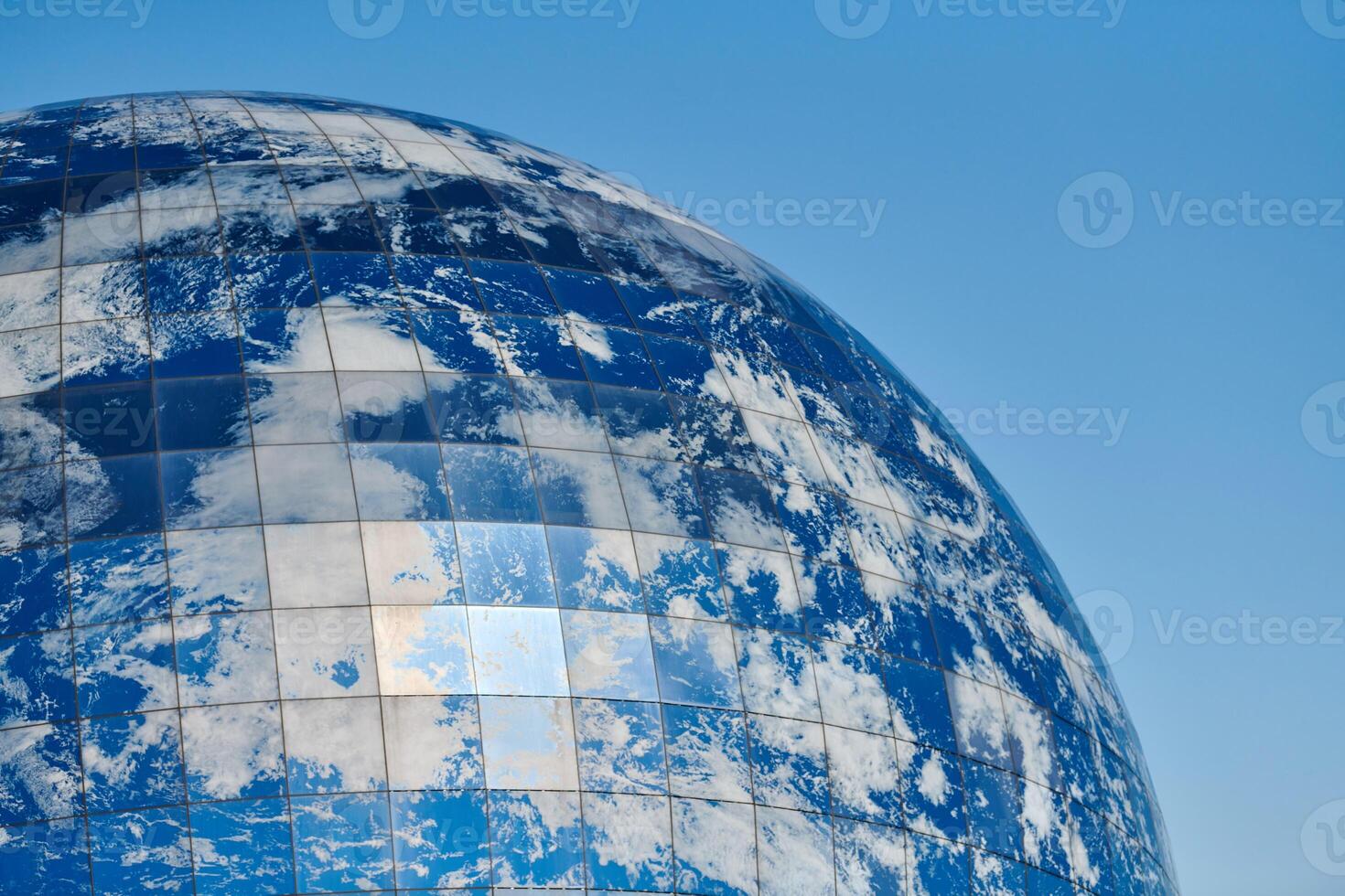 Earth planet modern building with clouds and blue sky, ecological architectural concept photo