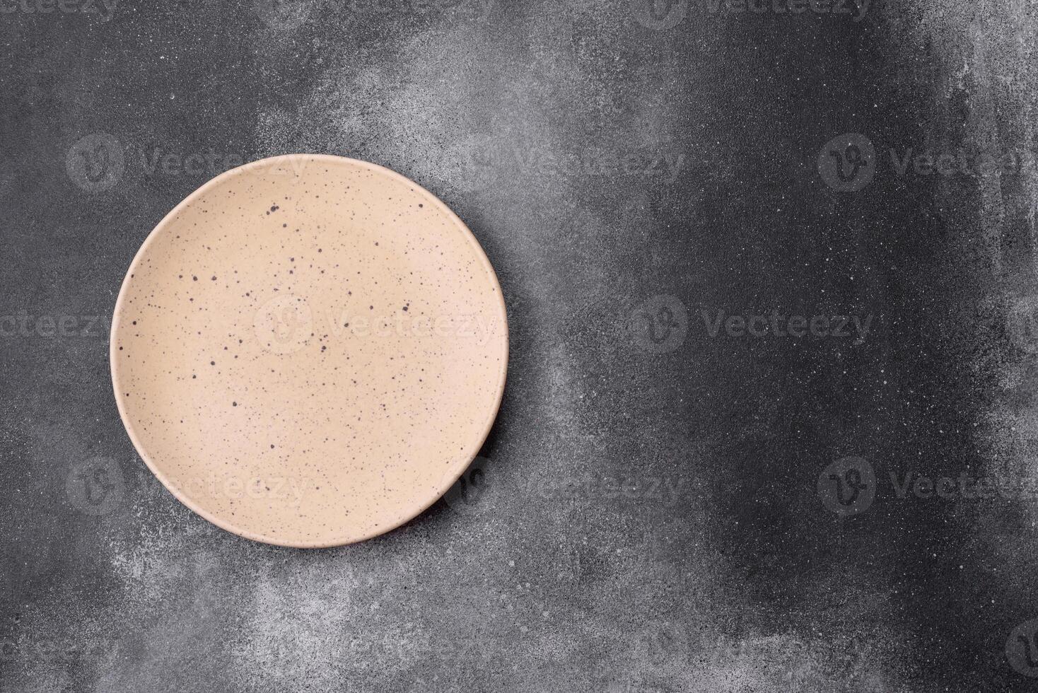 Empty ceramic plate on a dark textured background photo
