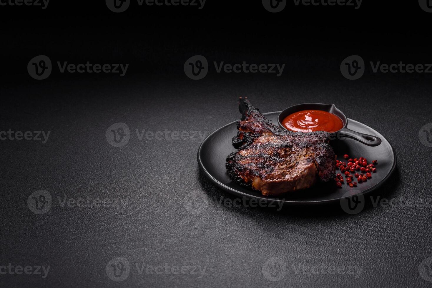 Juicy grilled beef tomahawk steak with salt, spices and herbs photo