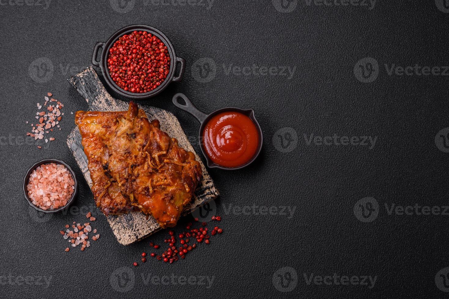 Delicious juicy grilled ribs with honey and mustard sauce with salt, spices and herbs photo