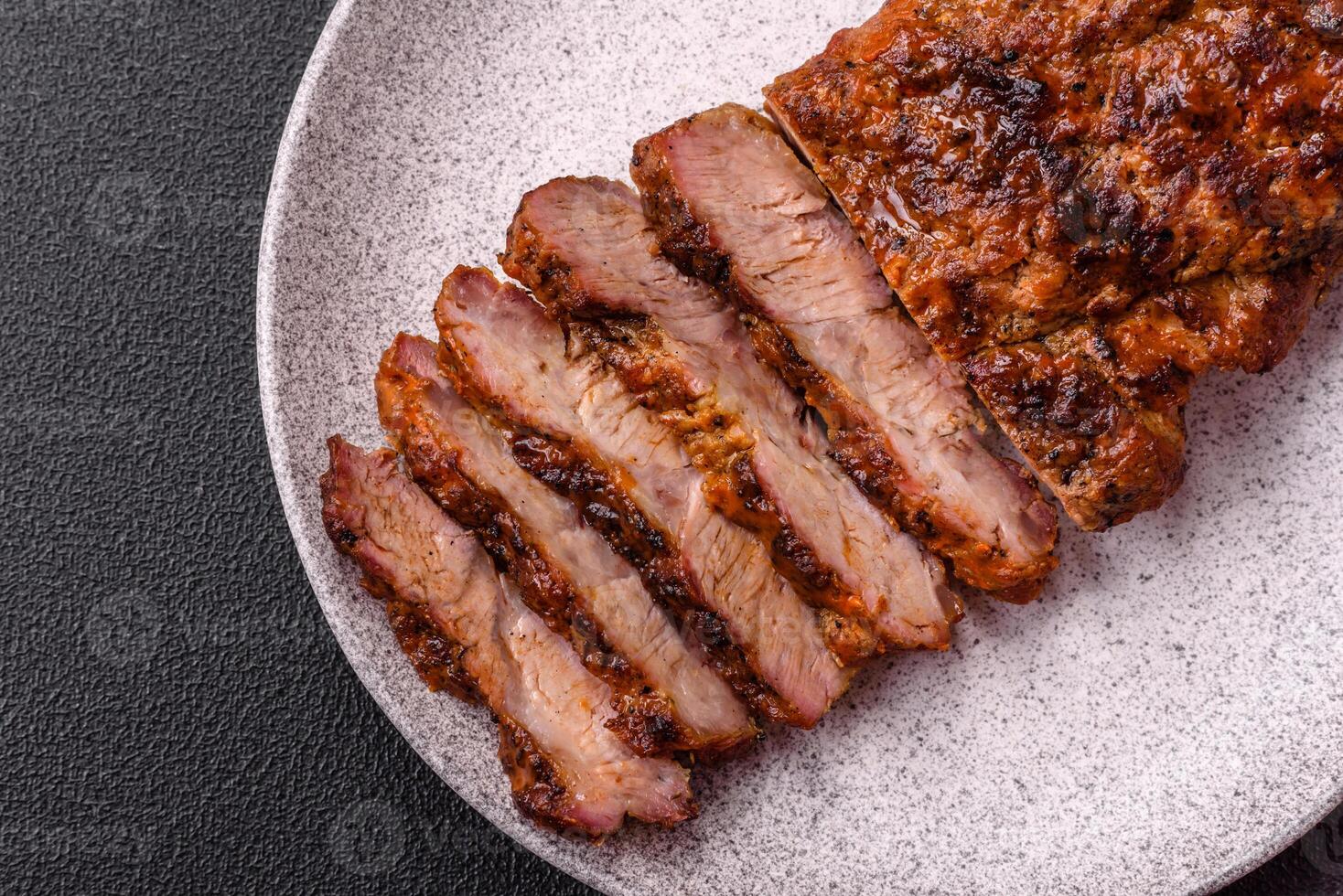 Fresh juicy delicious beef steak on a dark background photo