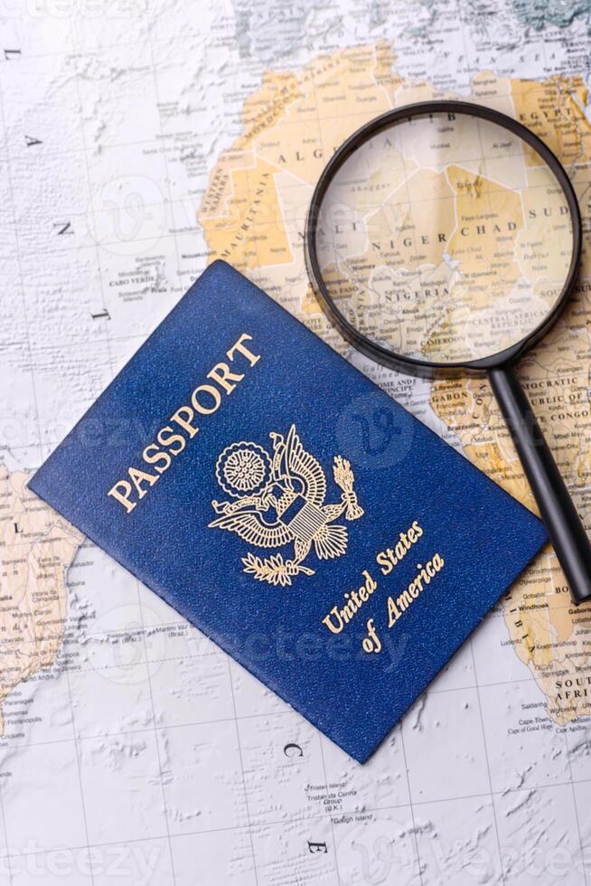 Conceptual background for travel with passport, magnifying glass, world map and money photo