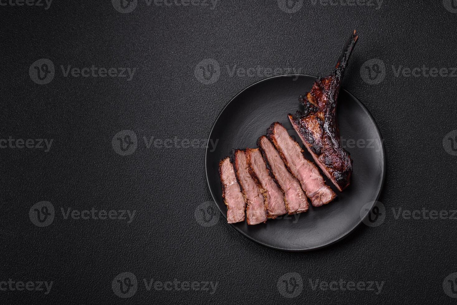 Juicy grilled beef tomahawk steak with salt, spices and herbs photo