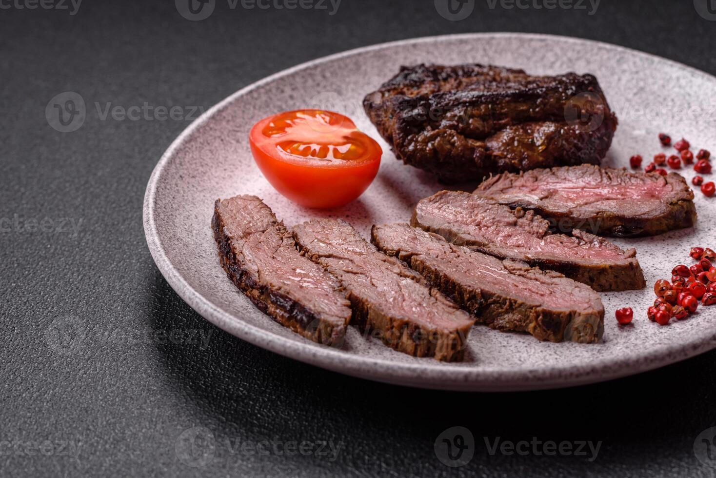 Fresh juicy delicious beef steak on a dark background photo