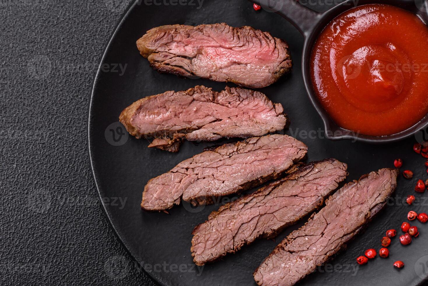Fresh juicy delicious beef steak on a dark background photo