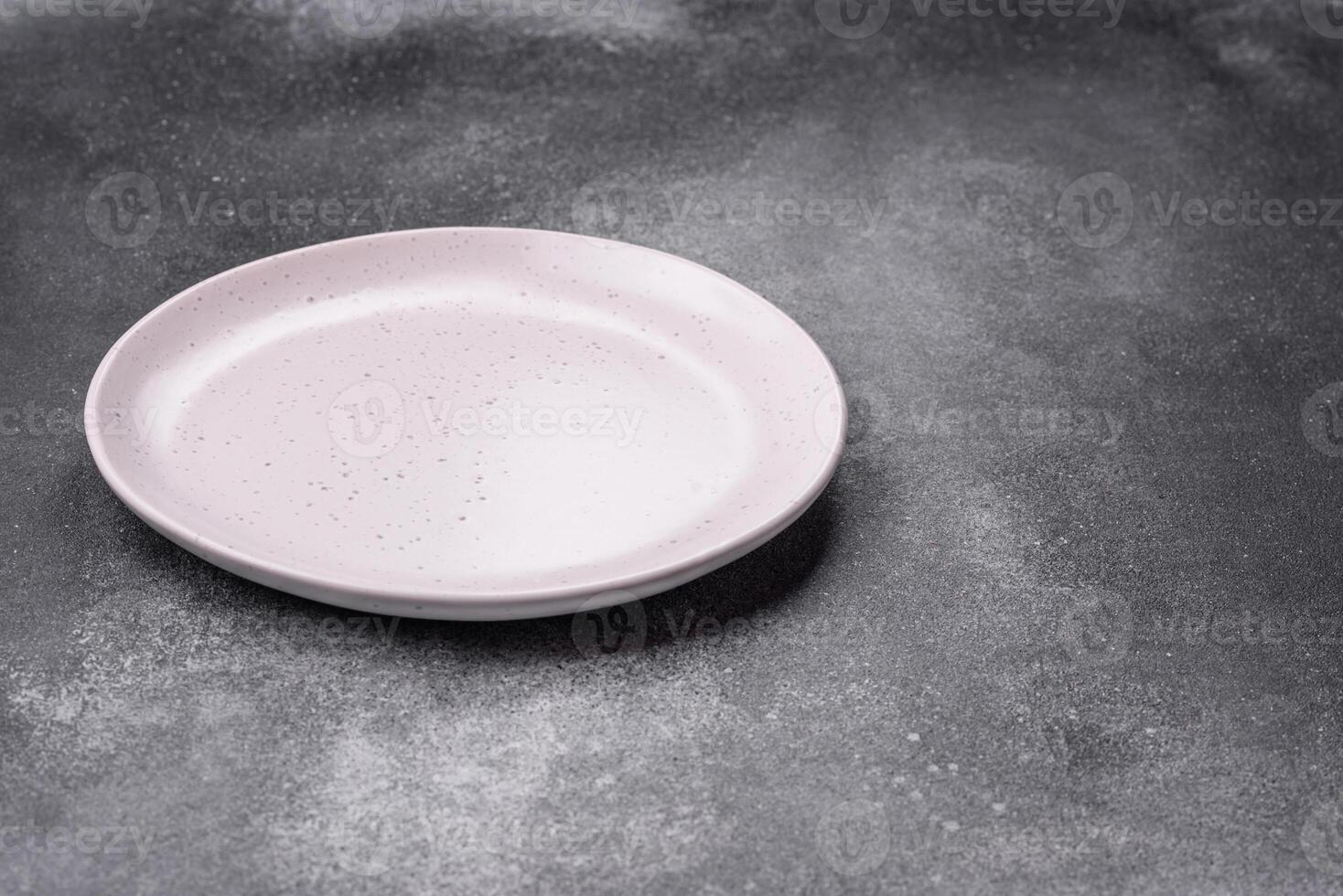 Empty ceramic plate on a dark textured background photo